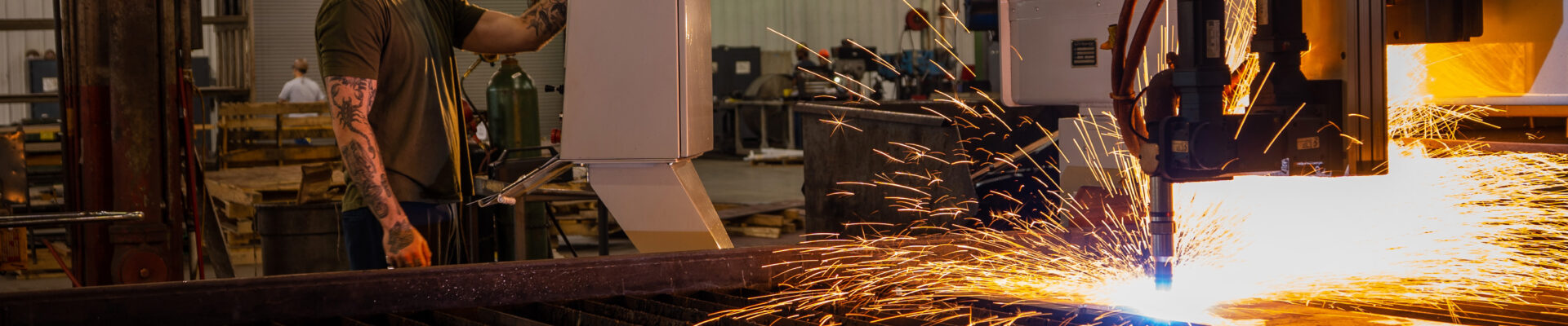 Man in hard hat works machine with fire