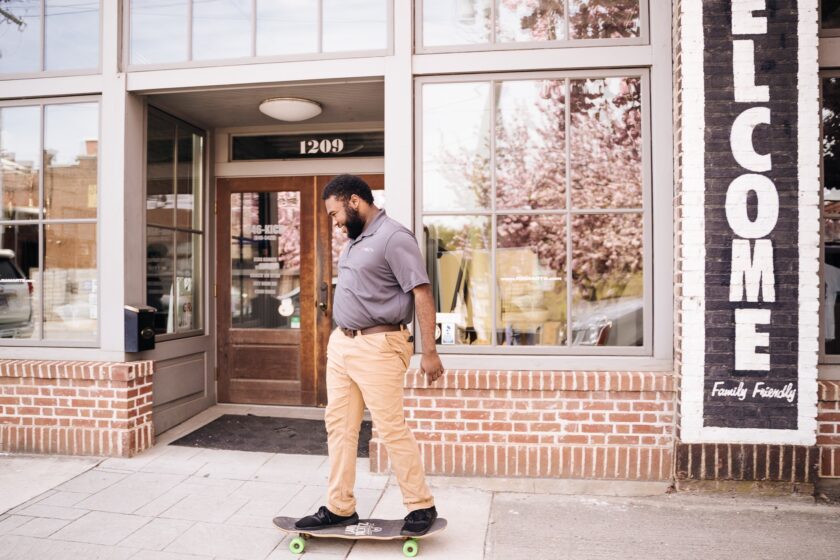 A man skateboards down a street.