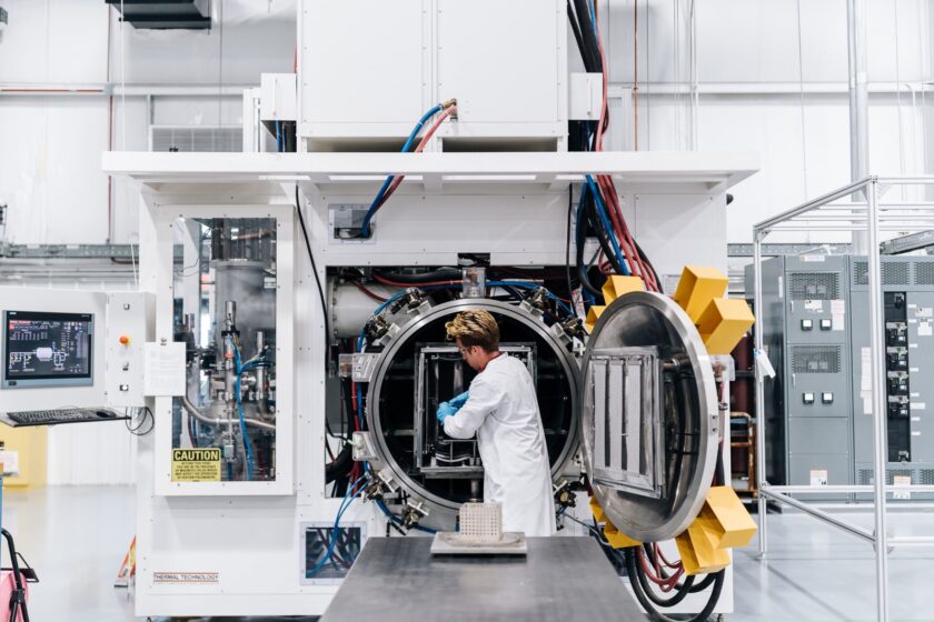 A BWXT employee works on machinery