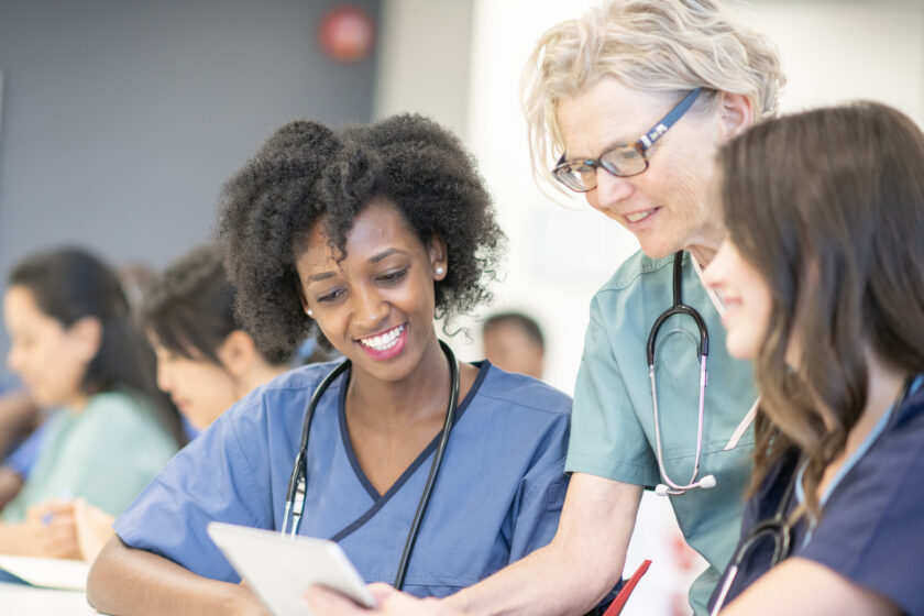 Nursing students and an instructor collaborating during a training session.