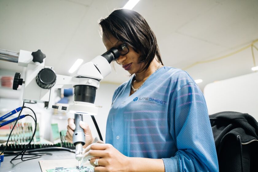 Woman looking into a microscope.