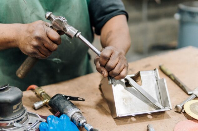 Close up of someone working with welding equipment.