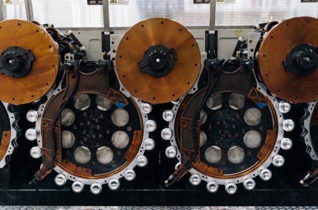 Close-up of industrial manufacturing machinery with copper discs.