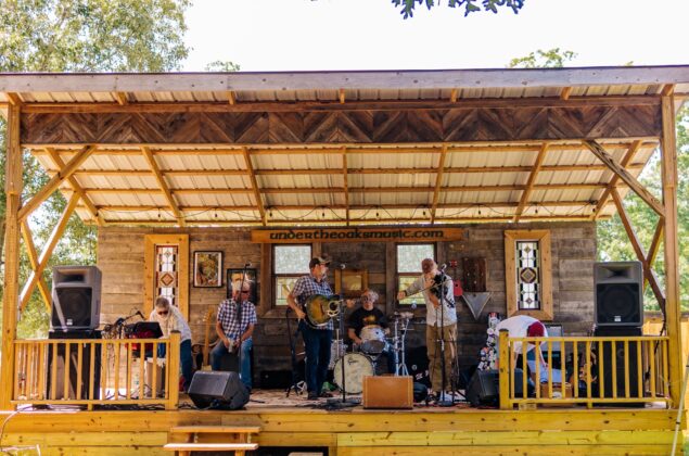 A local brand performs on an outdoor stage.