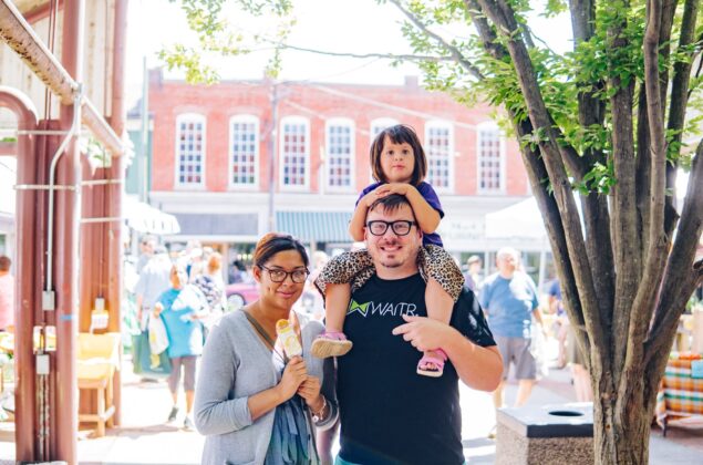 A family attends an outdoor festival.